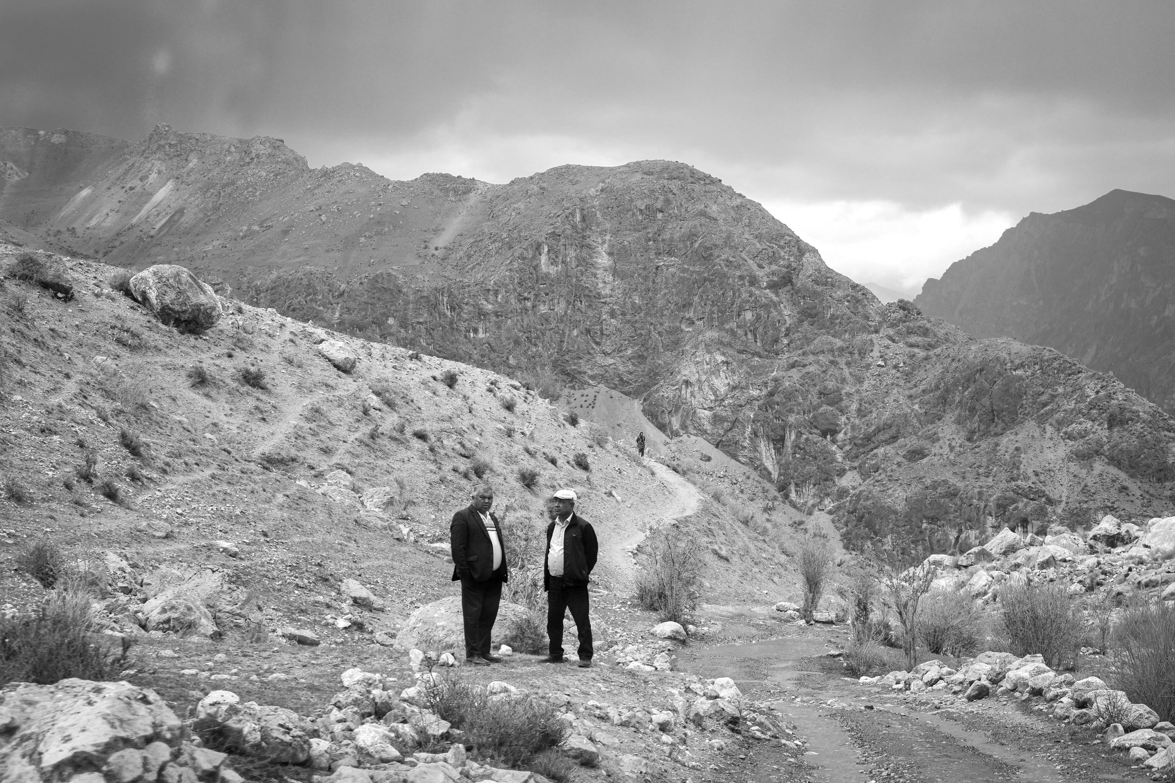 Two men standing in a mountain valley, Tajikistan