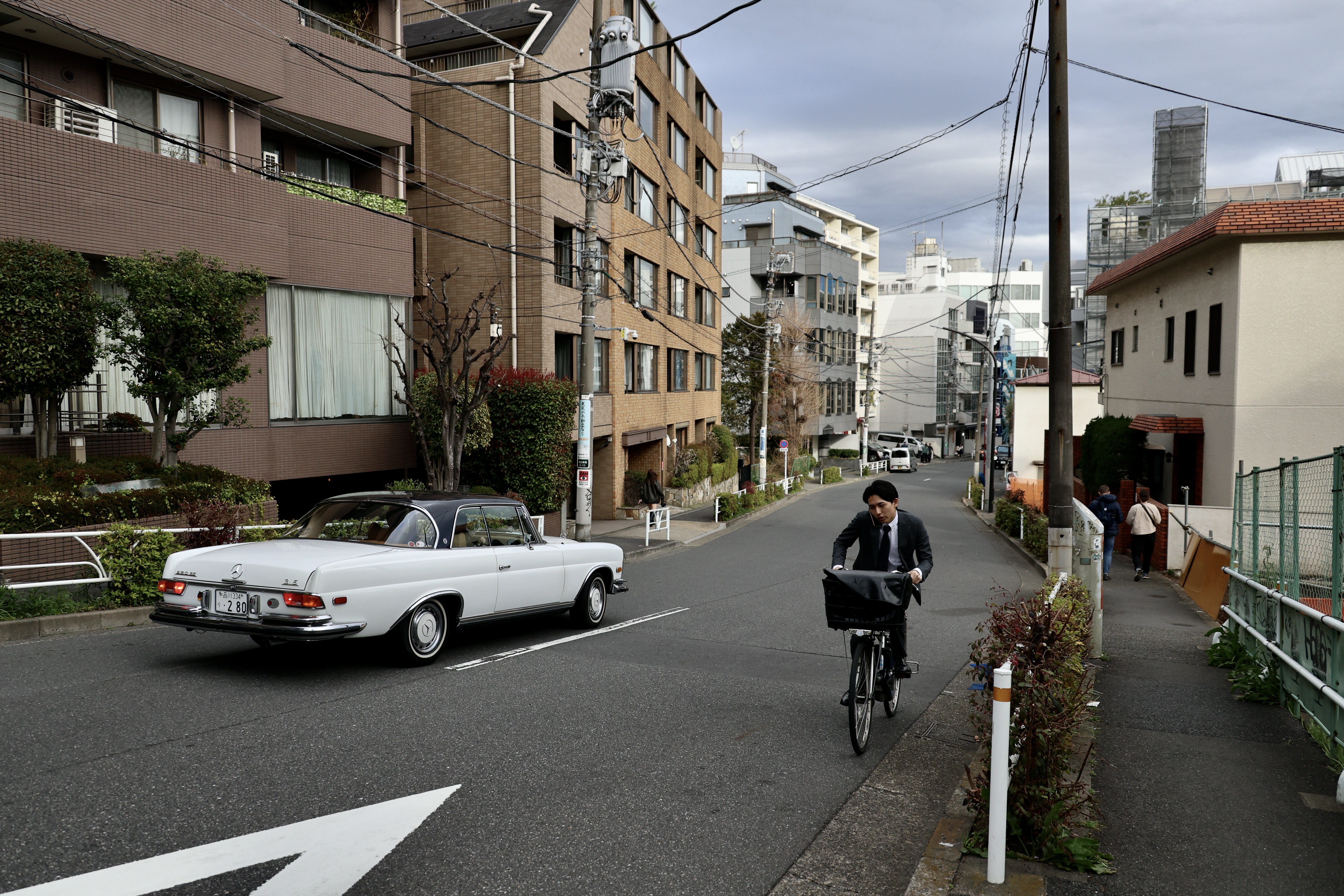Man cycles to work, Tokyo